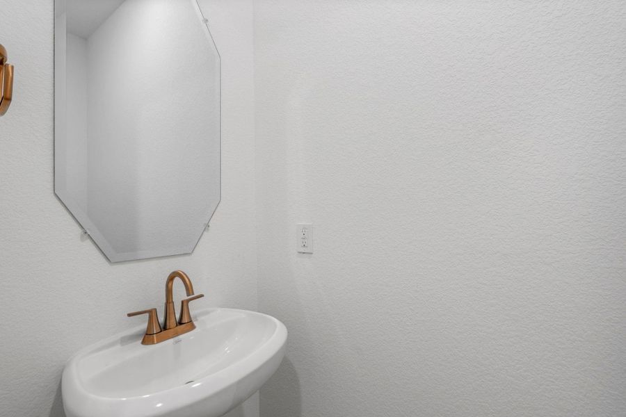 This charming home features a beautifully appointed half bath adjacent to the family room, perfect for welcoming guests and adding convenience to your daily life.