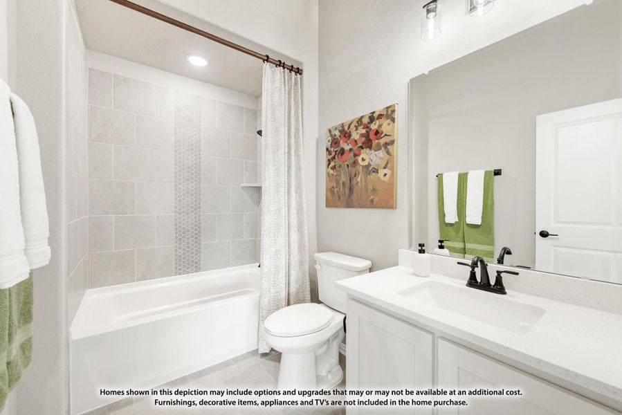 Bathroom with white vanity, tiled tub-shower combo, and large mirror