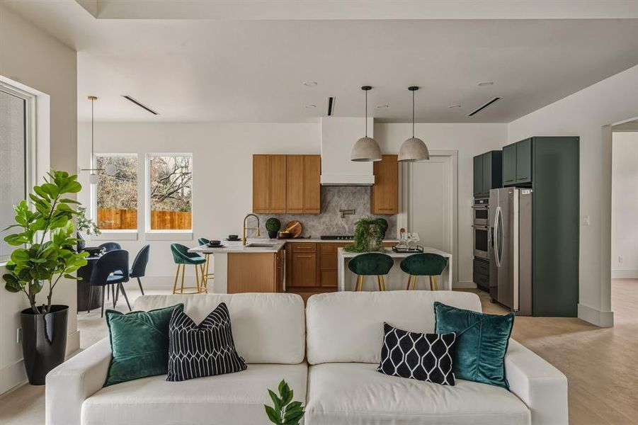 Living area featuring baseboards and light wood-style flooring