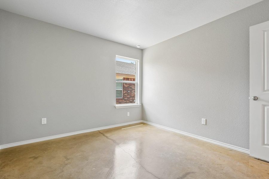 A well-lit room offers clean, unadorned walls and polished concrete flooring. A well-lit room offers clean, unadorned walls and polished concrete flooring.