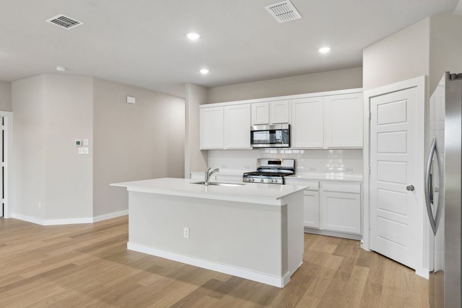 Kitchen in the Emmy II home plan by Trophy Signature Homes - REPRESENTATIVE PHOTO