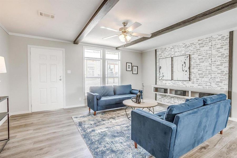 Living room with beam ceiling, light hardwood / wood-style floors, ceiling fan, and ornamental molding