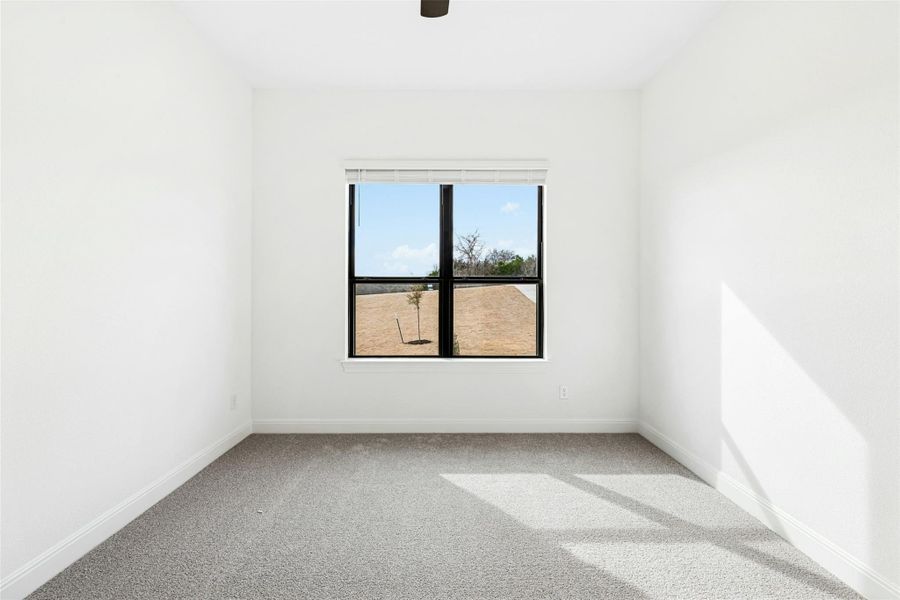 Unfurnished room with light colored carpet and baseboards