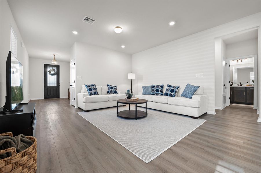 Living area featuring wood style flooring and recessed lighting Living area featuring wood style flooring and recessed lighting