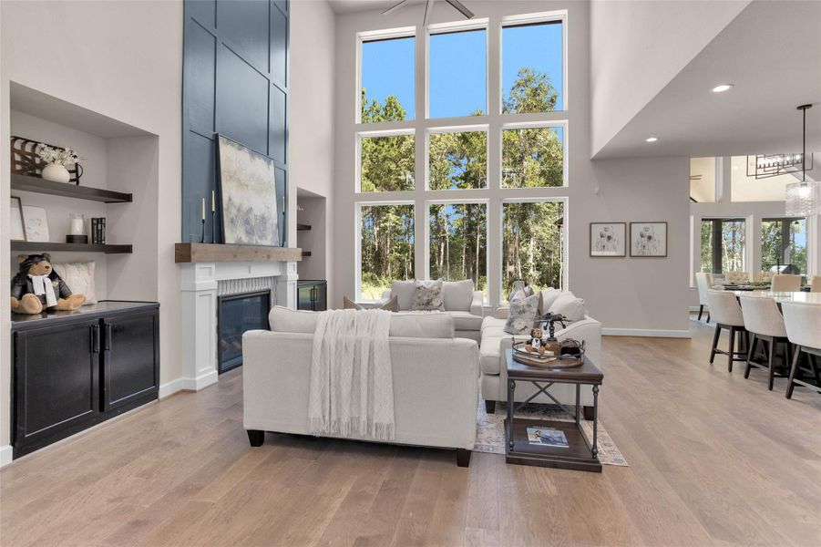 A dramatic wall of windows floods the space with natural light, while custom built-ins flank the fireplace for added charm and storage.