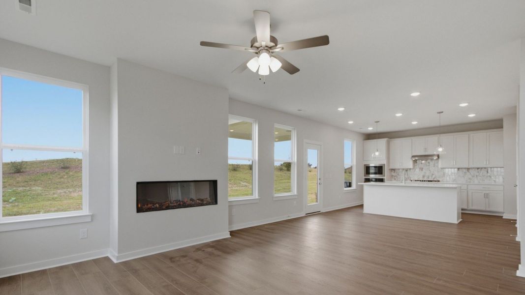 Open concept first floor with gathering room, cafe area, and kitchen