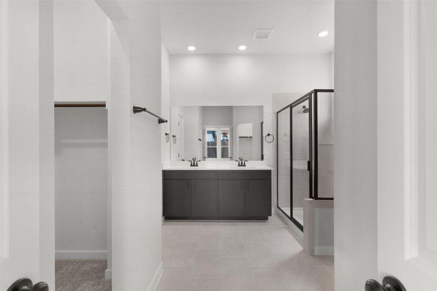 Full bathroom with a stall shower, double vanity, recessed lighting, and light tile patterned flooring Full bathroom with a stall shower, double vanity, recessed lighting, and light tile patterned flooring