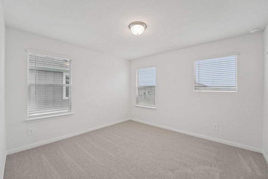 Spare room featuring light carpet and baseboards