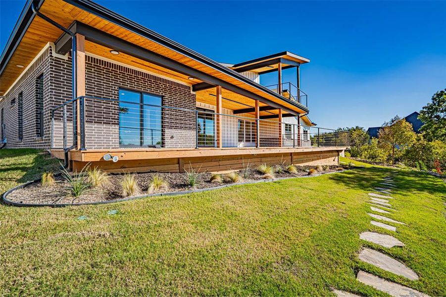 Rear view of property featuring brick siding and a lawn Rear view of property featuring brick siding and a lawn