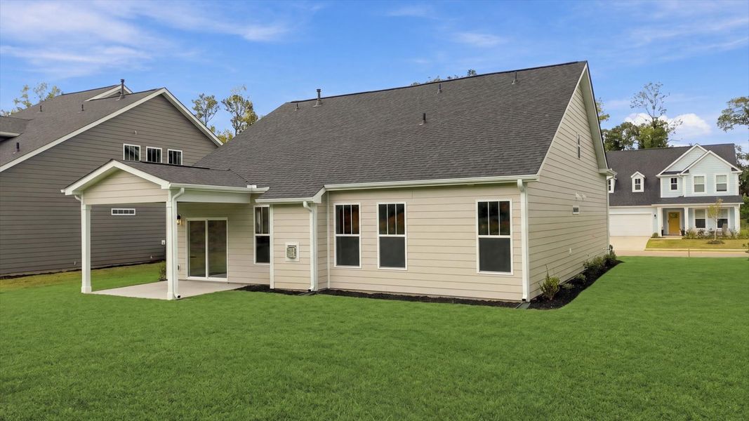 Warm and inviting outdoor living space with a covered rear porch and tasteful finishes at Creeks at Midway
