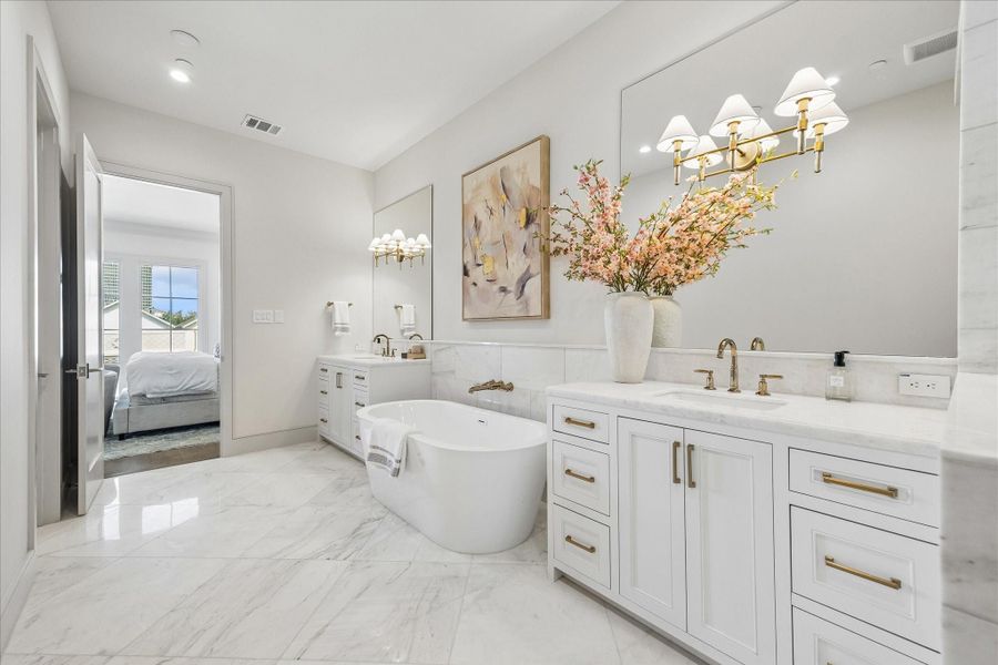 The 67" free-standing Mermaid soaking tub is the central point of the primary bathroom.