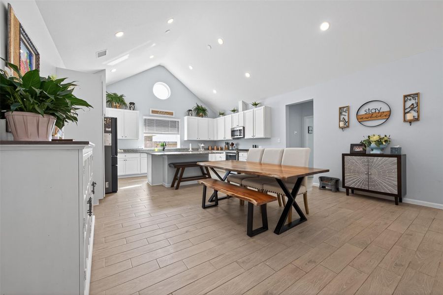Open-concept layout seamlessly connecting the kitchen and dining area, flooded with natural light