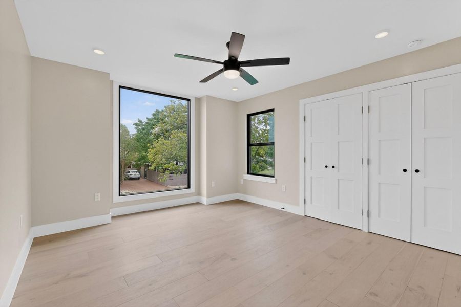 Hardwood floors and generous windows create an inviting, airy living space.
