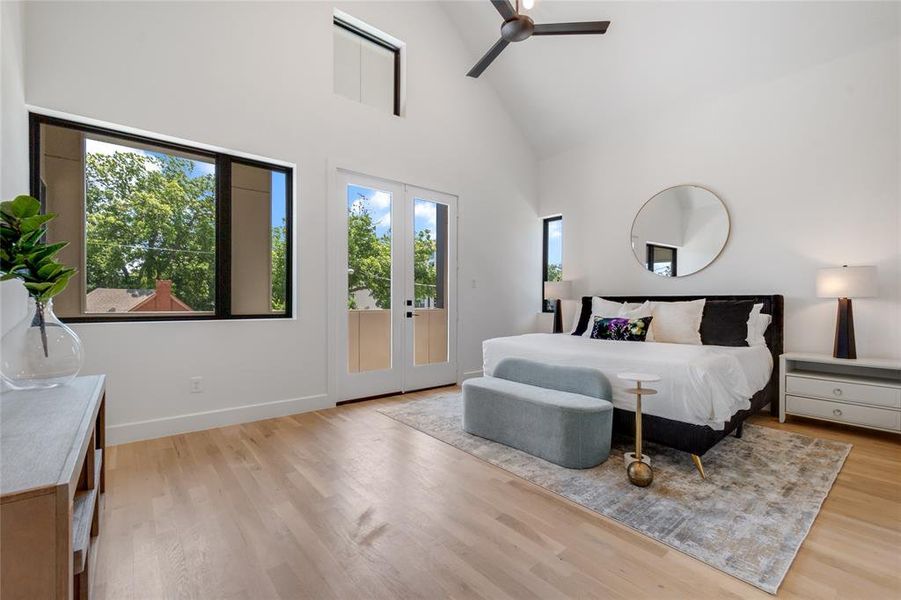 Bedroom featuring access to exterior, high vaulted ceiling, ceiling fan, and light hardwood / wood-style flooring