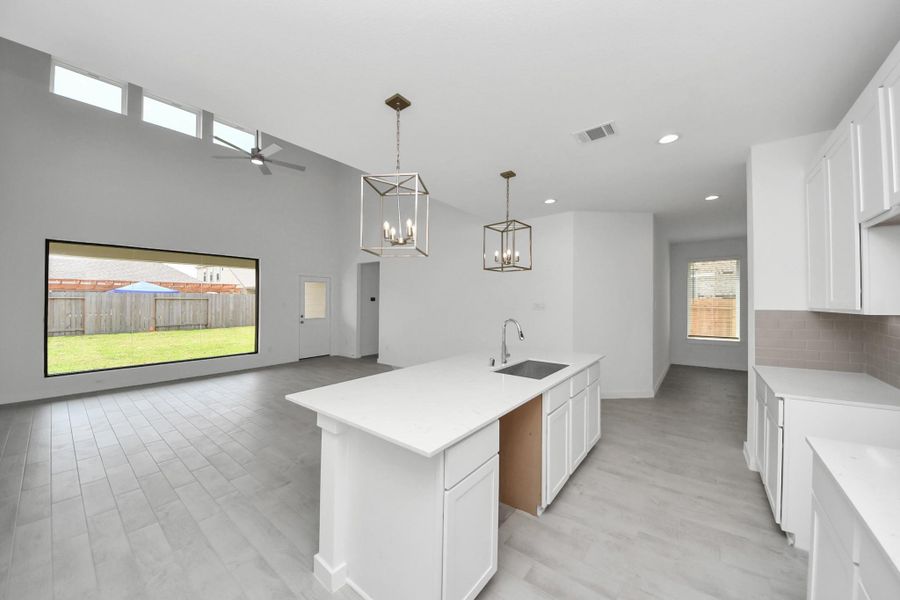 All of this overlooks your expansive family room, creating a perfect space for culinary delights and family gatherings. Sample photo of completed home with similar floor plan. Actual colors and selections may vary. All of this overlooks your expansive family room, creating a perfect space for culinary delights and family gatherings. Sample photo of completed home with similar floor plan. Actual colors and selections may vary.