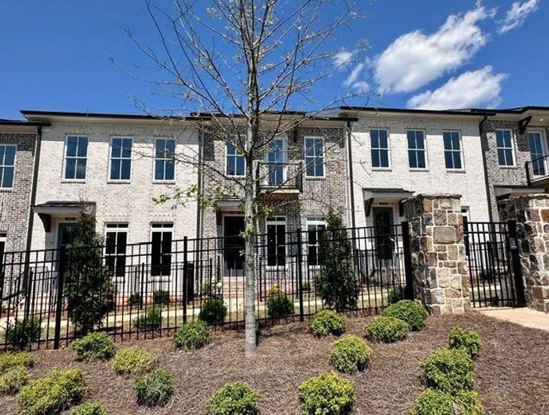 Front exterior of a new home in Ward's Crossing Townhomes, Johns Creek, GA, highlighting curb appeal (Image 1). Front exterior of a new home in Ward's Crossing Townhomes, Johns Creek, GA, highlighting curb appeal (Image 1).
