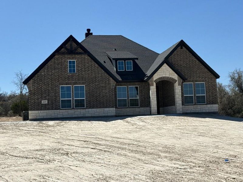 Front exterior of a new home in Oak Grove Addition, Springtown, TX, highlighting curb appeal (Image 2). Front exterior of a new home in Oak Grove Addition, Springtown, TX, highlighting curb appeal (Image 2).