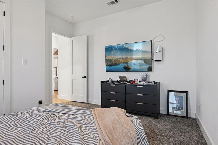 Bedroom featuring carpet flooring and baseboards Bedroom featuring carpet flooring and baseboards