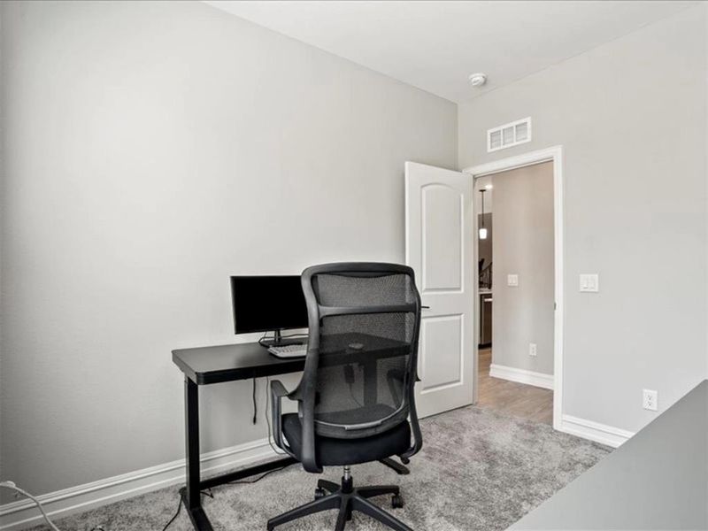 Tucked just off the living room, this space is perfect for a quiet home office—or ready to pivot into a guest room, playroom, or whatever life calls for next. Tucked just off the living room, this space is perfect for a quiet home office—or ready to pivot into a guest room, playroom, or whatever life calls for next.