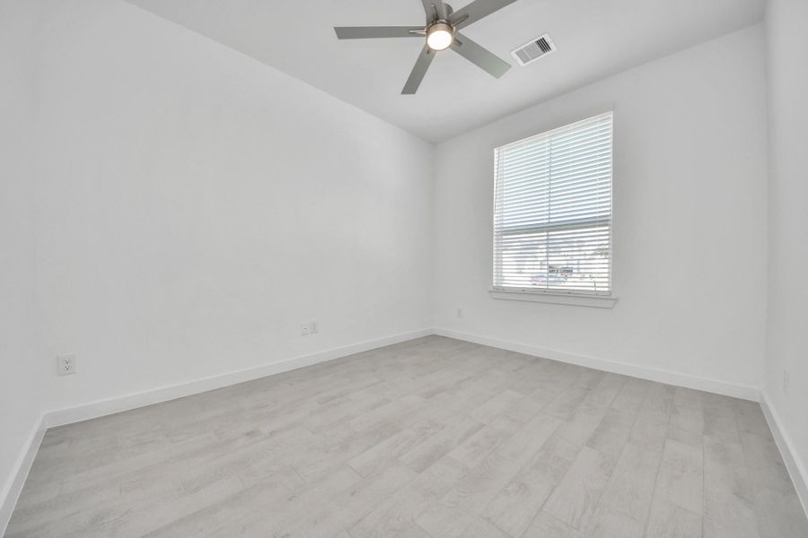 Step into the inviting home office, where elegant tile flooring adds a touch of freshness and comfort to the workspace. Natural light pours through the window, creating an inspiring environment for productivity and focus. Sample photo of completed home with similar floor plan. Actual colors and selections may vary.