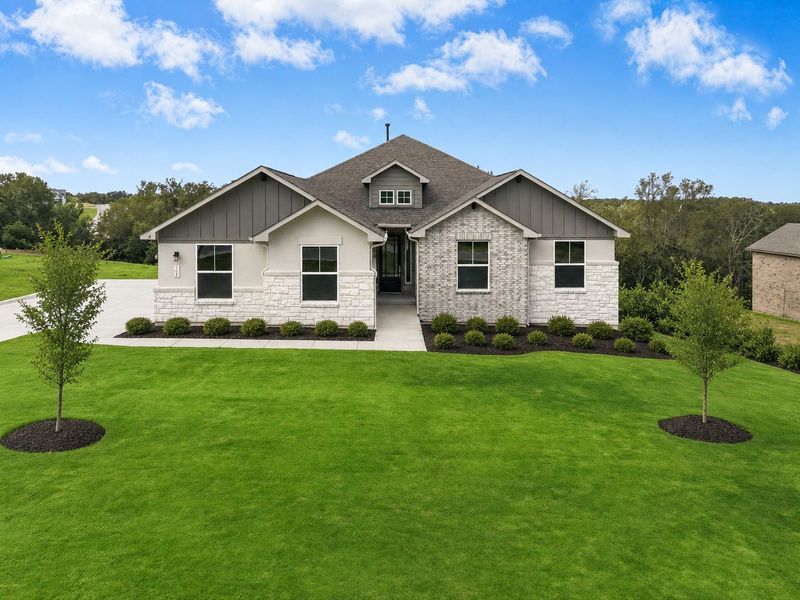 Front exterior of a new home in Double Eagle Ranch, Cedar Creek, TX, highlighting curb appeal (Image 1). Front exterior of a new home in Double Eagle Ranch, Cedar Creek, TX, highlighting curb appeal (Image 1).