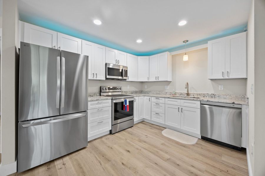 Full kitchen has ss appliances and above counter color-changing lighting on a sensor.