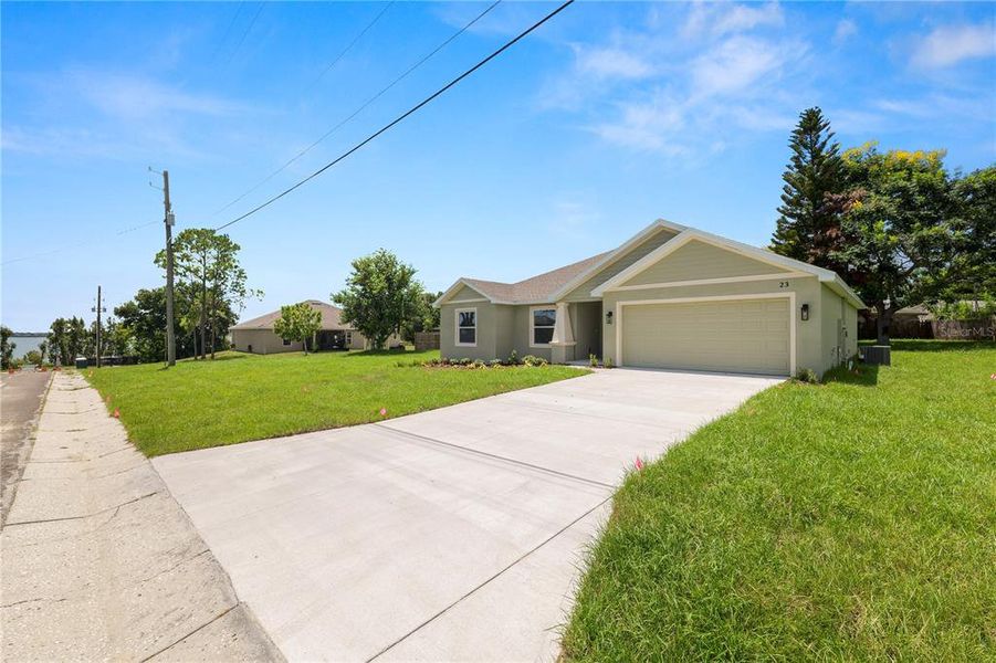 Front exterior of a new home in , Eagle Lake, FL, highlighting curb appeal (Image 24).
