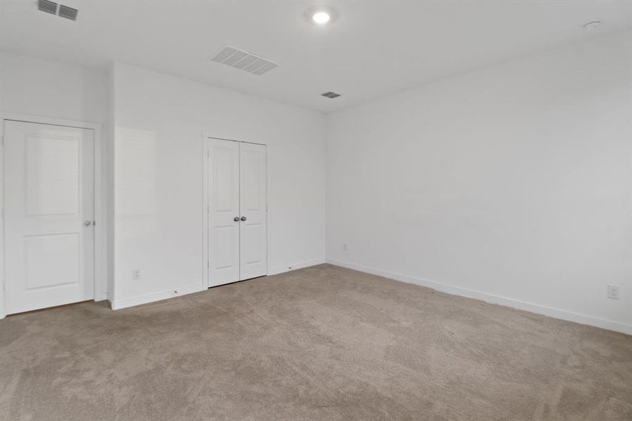 Unfurnished bedroom with carpet floors and a closet