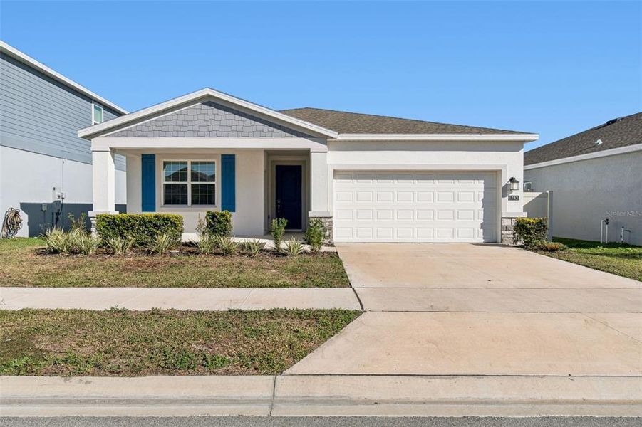 Front exterior of a new home in Ranches at Lake McLeod, Eagle Lake, FL, highlighting curb appeal (Image 27).