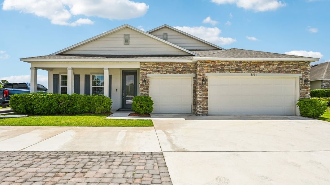 Front exterior of a new home in Vero Lake Estates, Vero Beach, FL, highlighting curb appeal (Image 21).