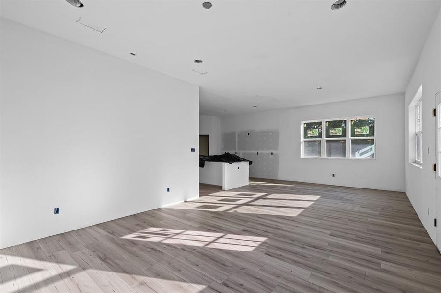 Unfurnished living room featuring wood finished floors Unfurnished living room featuring wood finished floors