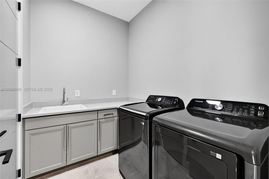Upstairs laundry room conveniently by the bedrooms w/ laundry tub