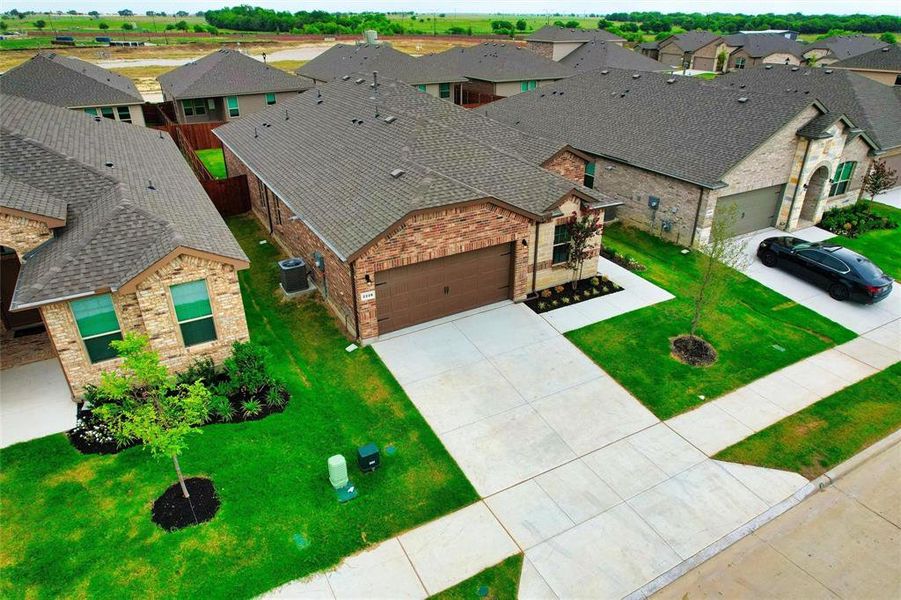 Front exterior of a new home in , Haslet, TX, highlighting curb appeal (Image 17). Front exterior of a new home in , Haslet, TX, highlighting curb appeal (Image 17).