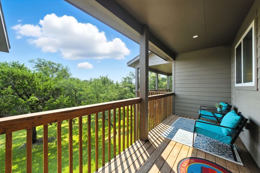 Upstairs terrace off of primary bedroom overlooking green space Upstairs terrace off of primary bedroom overlooking green space