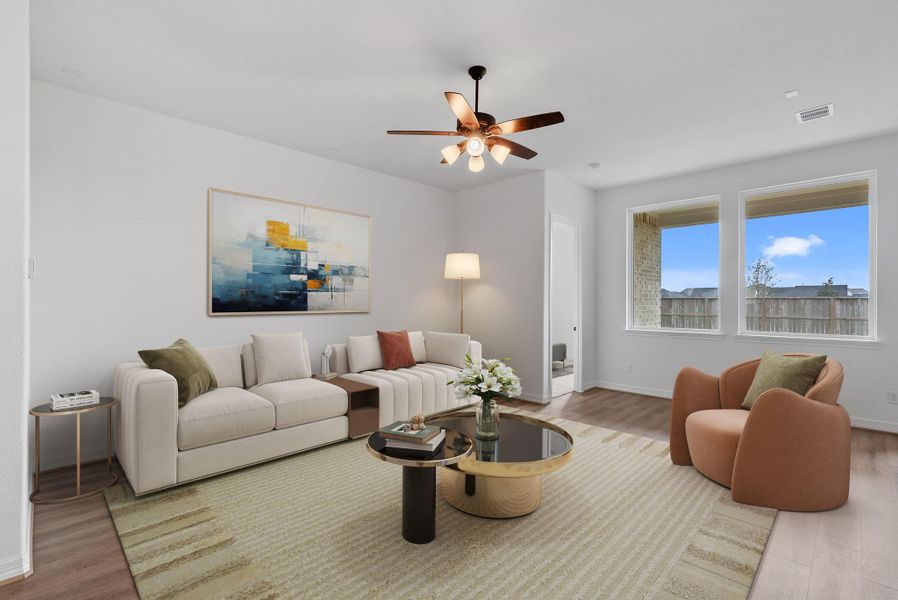 Living room filled with natural light from large windows, creating a warm and inviting space.