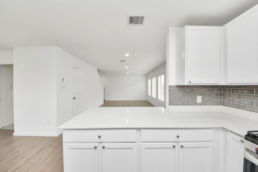 Open kitchen keeps you connected to family and guests while entertaining.