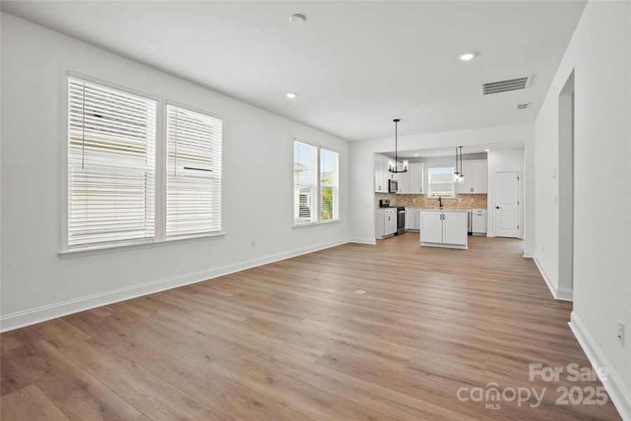 Enjoy 9' ceilings, low-maintenance EVP flooring throughout living areas, and large windows with included blinds!