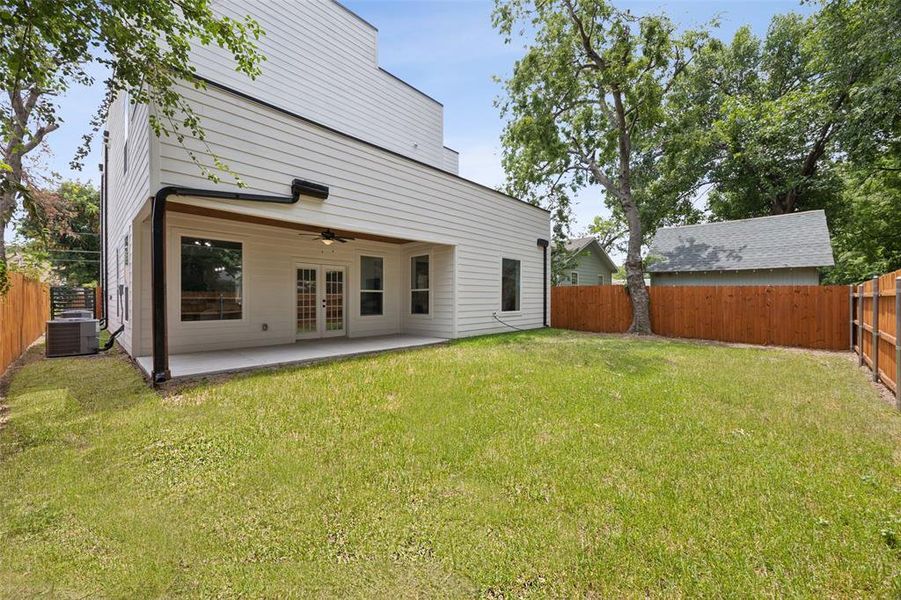 Rear view of house featuring french doors and a ceiling fan