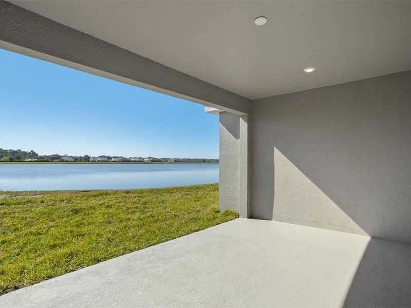 A triple sliding glass door opens to outdoor living space on your covered lanai - Everly by Highland Homes