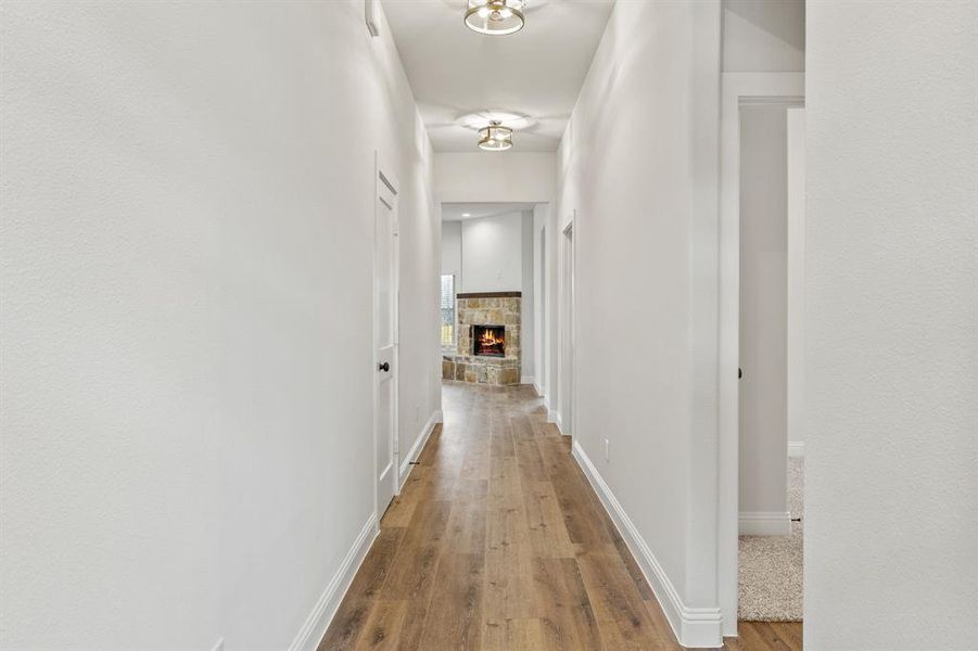 Hall featuring light wood-type flooring and baseboards