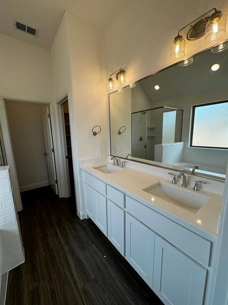 Bathroom featuring vanity, hardwood / wood-style flooring, and independent shower and bath