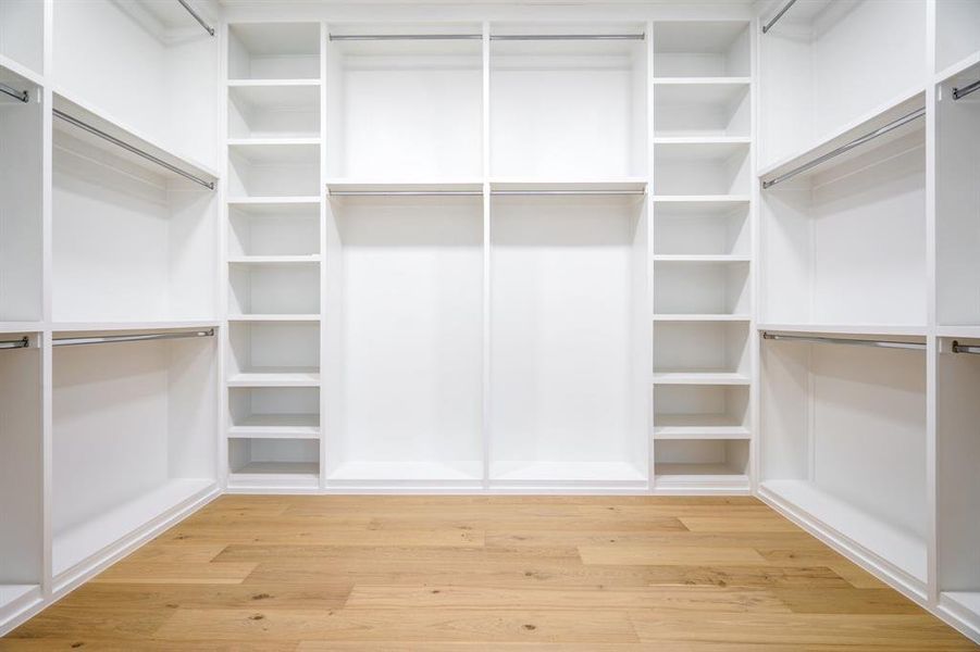 Spacious closet featuring light hardwood / wood-style flooring