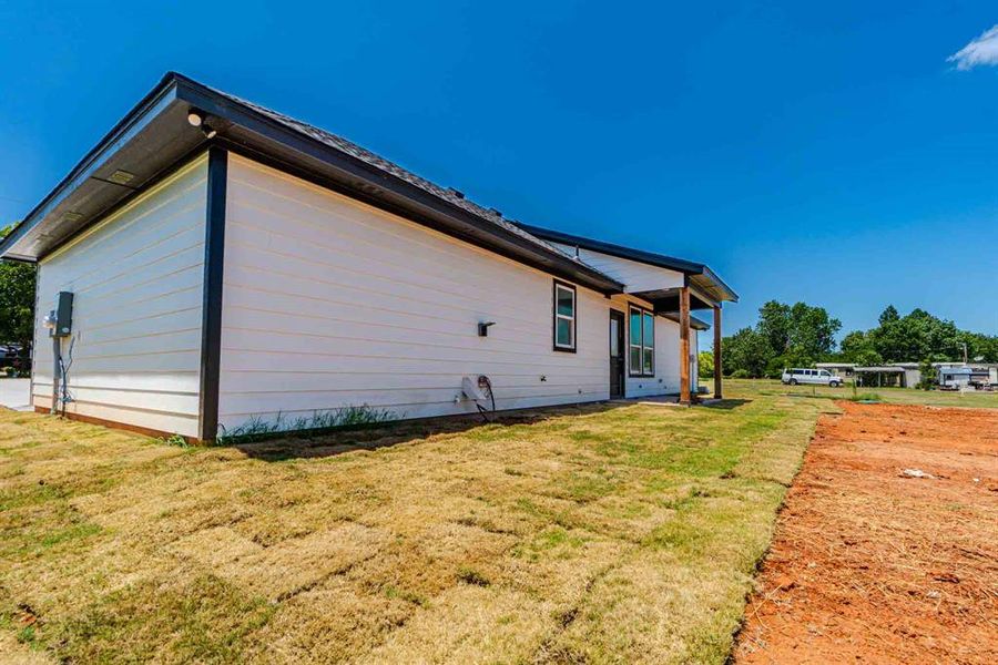View of side of property featuring a lawn View of side of property featuring a lawn