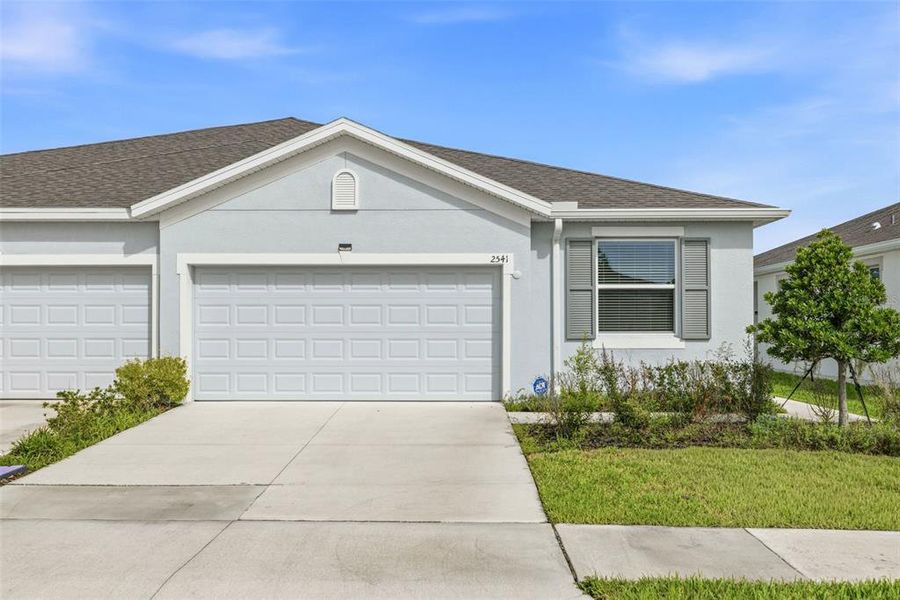 Front exterior of a new home in Woodcreek, Wesley Chapel, FL, highlighting curb appeal (Image 2). Front exterior of a new home in Woodcreek, Wesley Chapel, FL, highlighting curb appeal (Image 2).