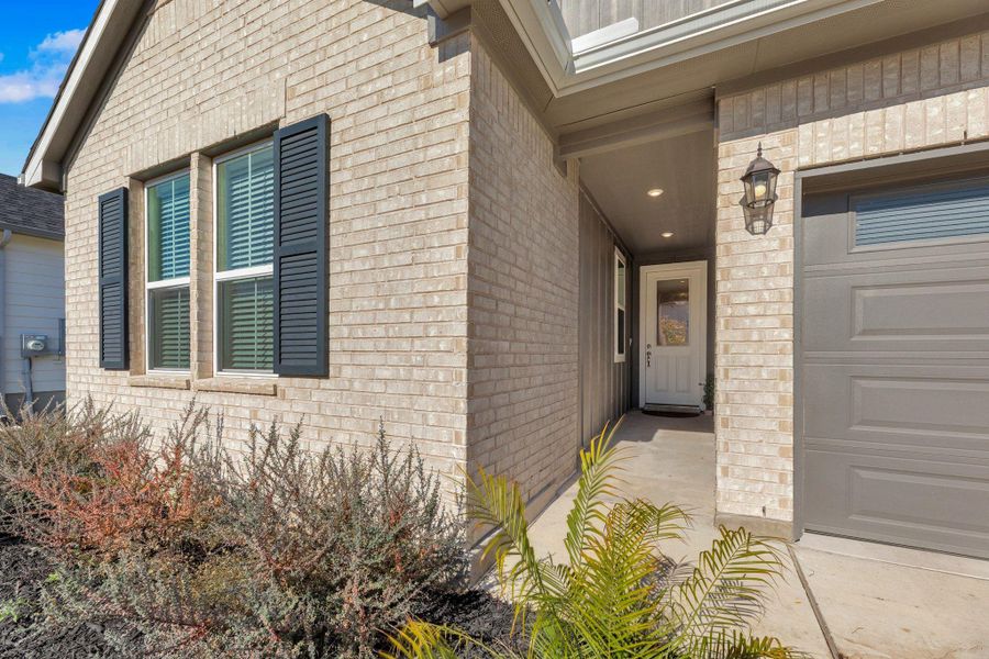 Exterior details and patio area of a home in Seasons at Carillon, Manor (Image 23).