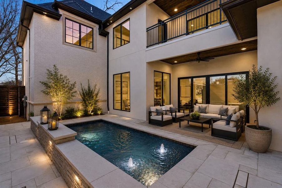 This is a ,cozy modern patio at dusk AI image of what the back area could look like.