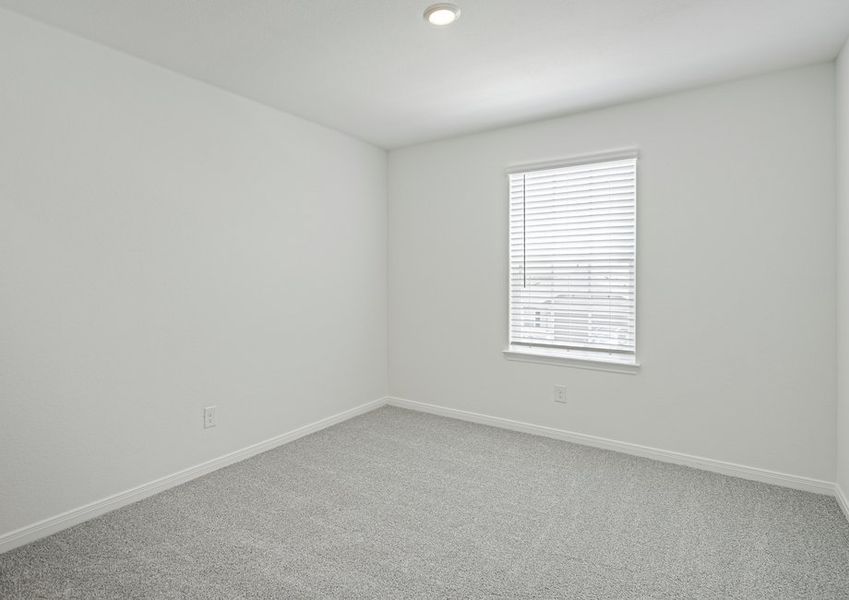 Secondary bedroom with faux wood window blinds