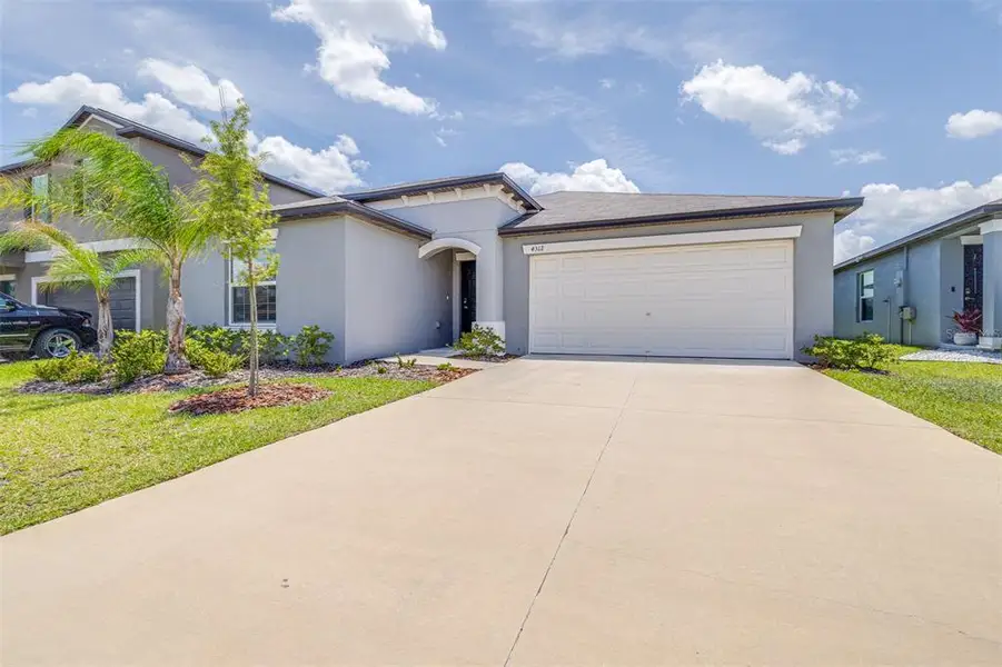 Front exterior of a new home in Wind Meadows South, Bartow, FL, highlighting curb appeal (Image 2). Front exterior of a new home in Wind Meadows South, Bartow, FL, highlighting curb appeal (Image 2).