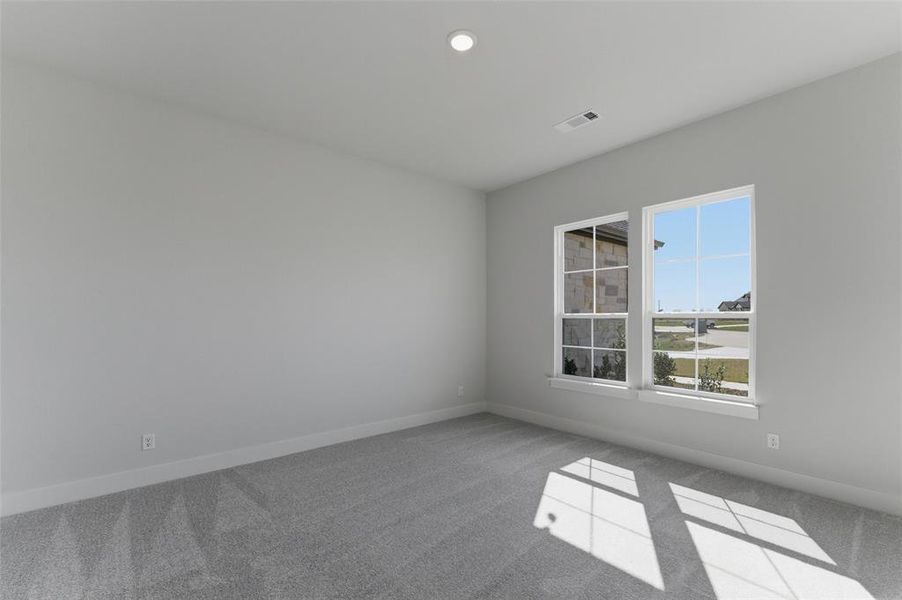 Empty room featuring light carpet and recessed lighting Empty room featuring light carpet and recessed lighting