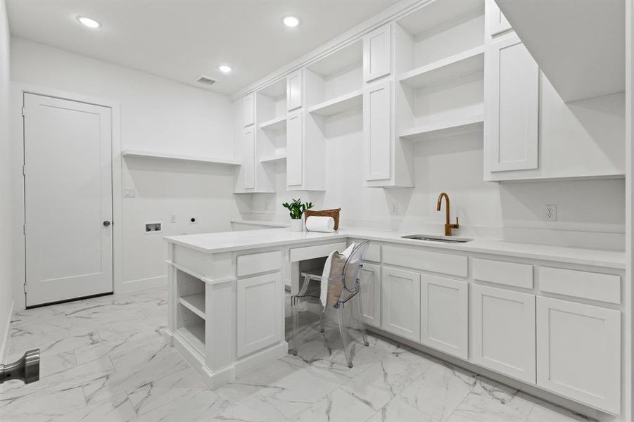 Kitchen featuring open shelves, white cabinetry, recessed lighting, light marble finish floors, and a peninsula